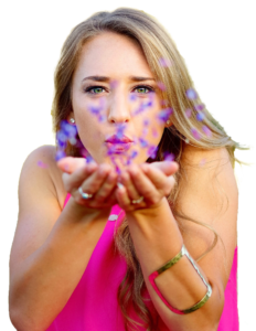 Young Woman Blowing Flower Petals
